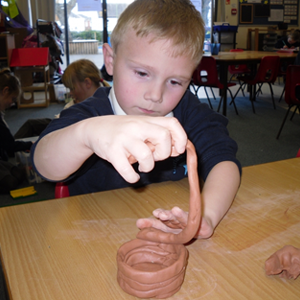 Boy-Making-a-pot-with-clay